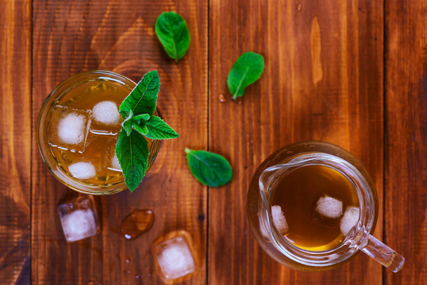 Kombucha tea with ice and mint on a wooden table. Top view. - Foto, Imagem
