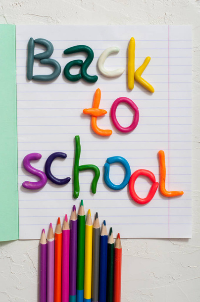 School supplies and inscription back to school on color background - Fotoğraf, Görsel