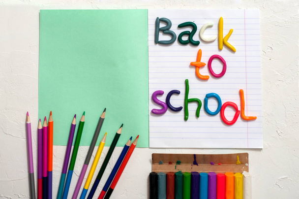 School supplies and inscription back to school on color background - Foto, imagen