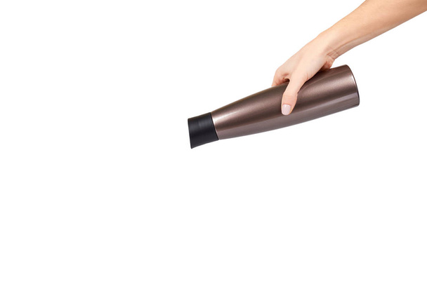 Hand with brown metal thermos, travel mug for hot drinks. - Fotó, kép