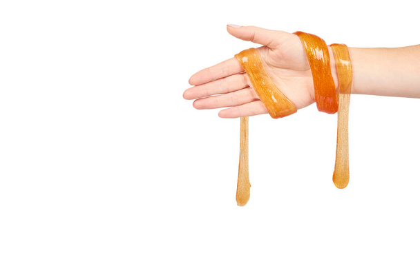 kid playing orange slime with hand, transparent toy - Photo, image