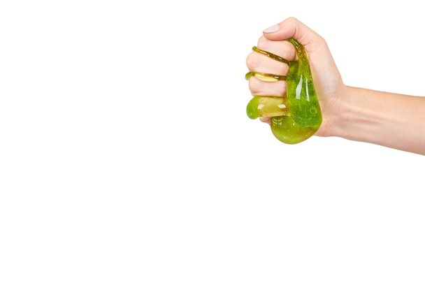 teenager playing green slime with hand, transparent toy - Foto, imagen