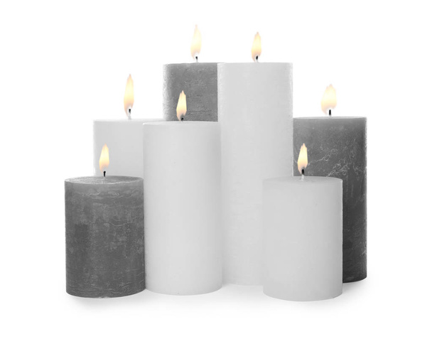 Many alight wax candles on white background - Foto, Imagen