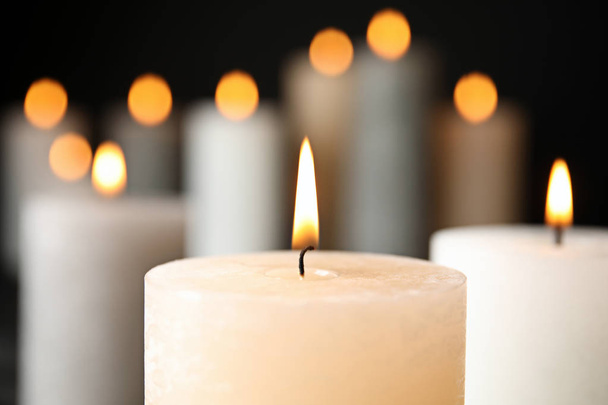 Alight wax candle on blurred background, closeup - Foto, afbeelding