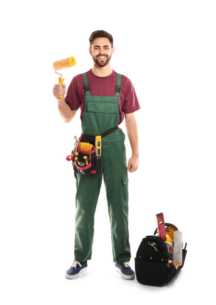 Full length portrait of professional construction worker with tools on white background - Foto, Imagem