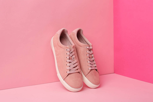 New comfortable sneakers with laces on color background - Photo, image