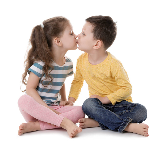 Cute little boy and girl kissing on white background - Zdjęcie, obraz