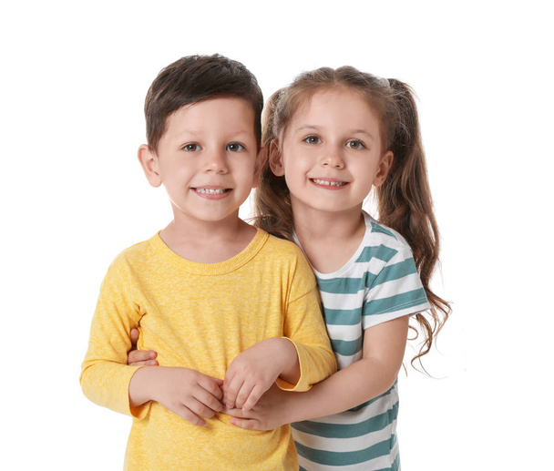 Cute little boy and girl hugging on white background - Foto, Imagen