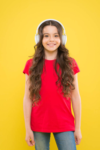 The only music that matters. Adorable girl enjoying music on yellow background. Little child listening to music in stereo headphones. Music education for small children - Foto, Imagem