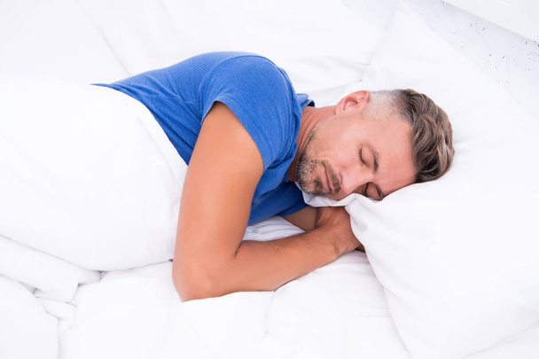 Sleeping beauty. Man handsome guy lay in bed. Get enough amount of sleep every night. Tips sleeping better. Bearded man sleeping face relaxing on pillow. Pleasant relaxation concept. Perfect rest - Foto, Imagen