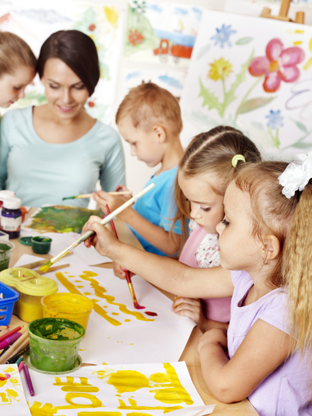 Children with teacher painting. - Photo, image
