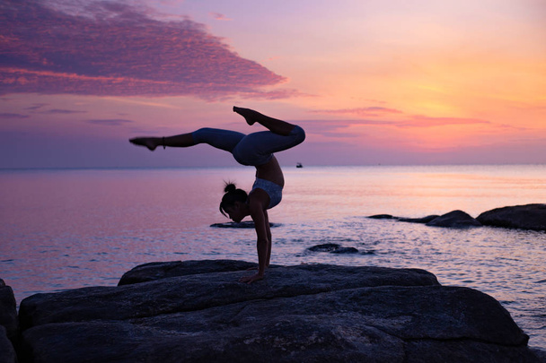 Asian girl practice Yoga on the beach Sunrise morning day - Фото, зображення