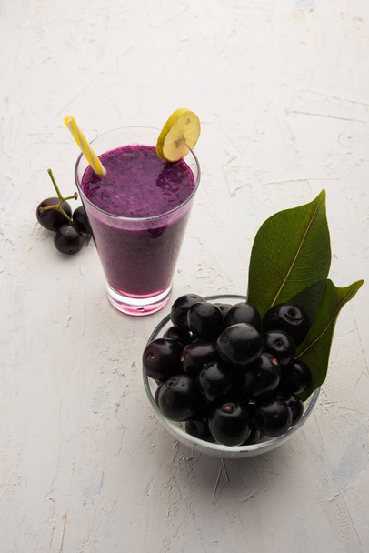 Juice of jamun fruit in a glass also called as java plum, jambolan plum, jambhul, syzygium cumini - Fotoğraf, Görsel