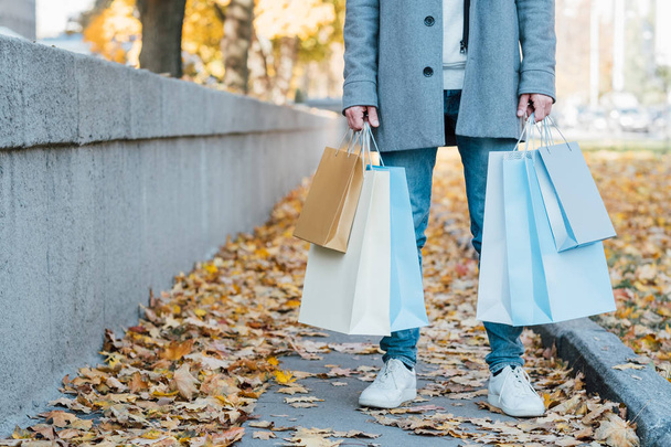new season shopping man bags fall sidewalk - Fotoğraf, Görsel