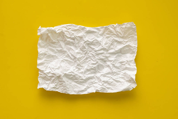 flat lay crumpled white paper sheet isolated on the table, background texture and copy spaces - Photo, Image