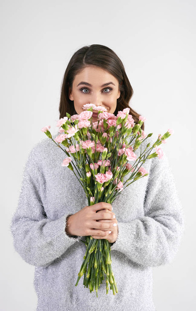 Portrait of beautiful woman holding bunch of flowers - Photo, Image