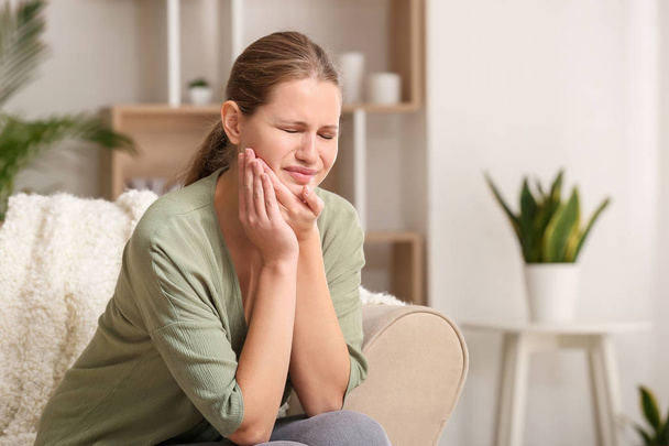 Young woman suffering from toothache at home - Foto, imagen