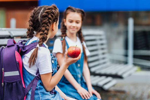 beautiful girls with red apple, selective focus - Fotografie, Obrázek