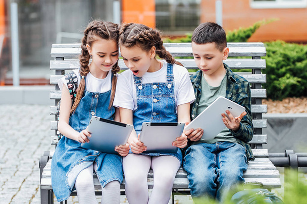Three cute children using digital tablets, selective focus - Valokuva, kuva