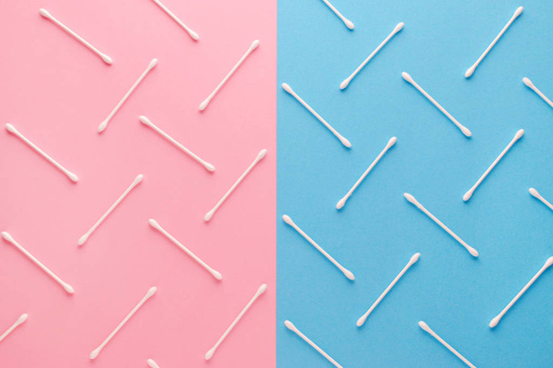 pink and blue background and white cotton swabs, flat lay - Fotó, kép