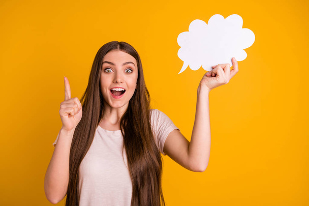 Close up photo beautiful she her lady very long hair hold hand paper mind cloud express excited feelings geek direct indicate finger empty space wear casual pastel t-shirt isolated yellow background - Φωτογραφία, εικόνα