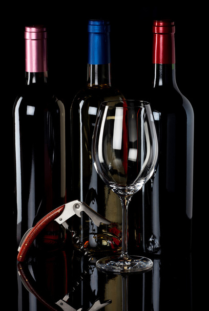 Three wine bottles and corkscrew - Foto, Imagen
