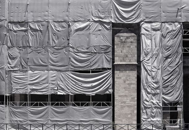 Building covered with wrinkled tarpaulin canvas - Photo, Image