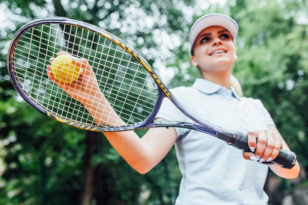 tennis player on tennis court, focus on foreground - Fotó, kép