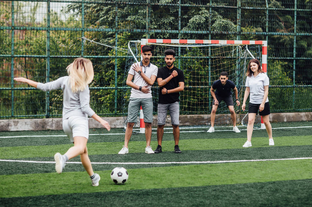 friends playing football together, selective focus - Foto, afbeelding