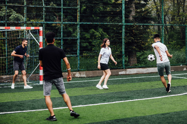 friends playing soccer on field, selective focus - 写真・画像