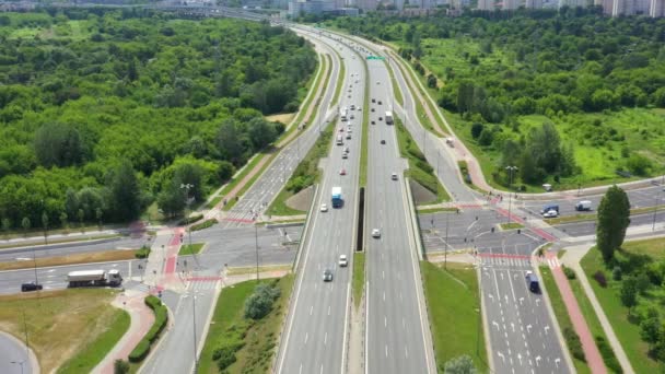 Top view of freay road. Clip. Highway with traffic in forest. Suburban highway with cars and trucks. Travel and transportation. Aerial view - Footage, Video
