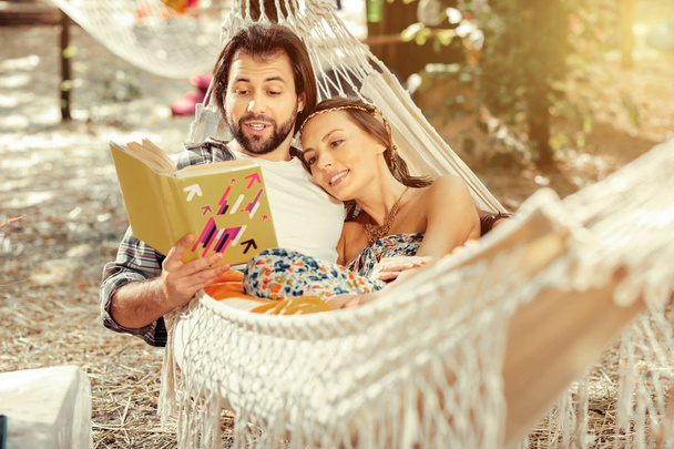 Nice handsome man reading a book with his girlfriend - Foto, immagini