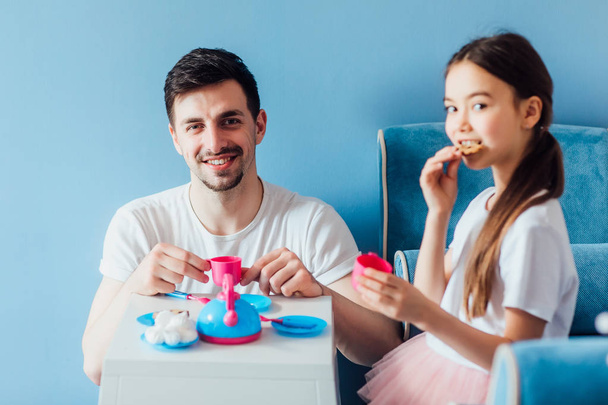 family eating cookies in bedroom, selective focus - Fotografie, Obrázek