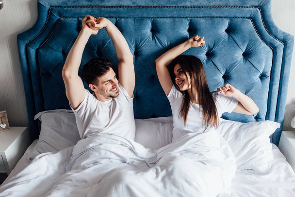 young couple in bed together, focus on foreground - Photo, Image