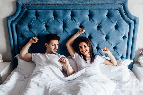 young couple in bed together, focus on foreground - Φωτογραφία, εικόνα