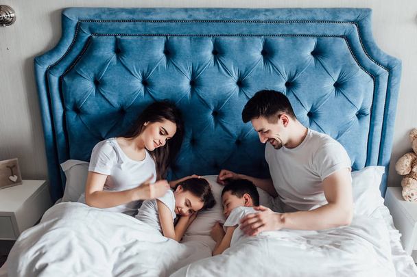 family spending time together in bed at home   - Φωτογραφία, εικόνα