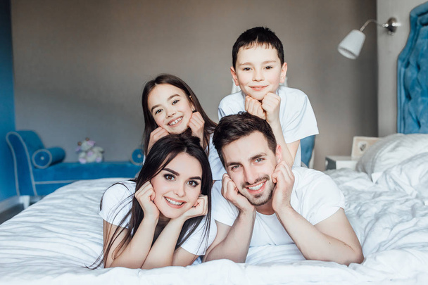 family spending time together in bed at home   - Foto, imagen