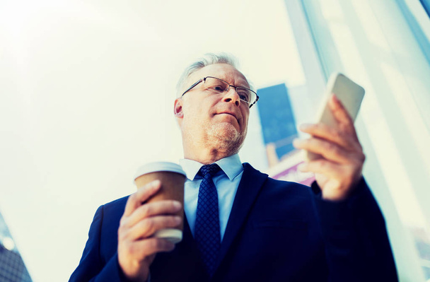 businessman with smartphone and coffee in city - Foto, Bild