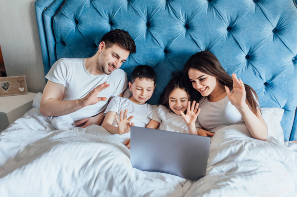 family spending time together in bed at home   - Fotografie, Obrázek