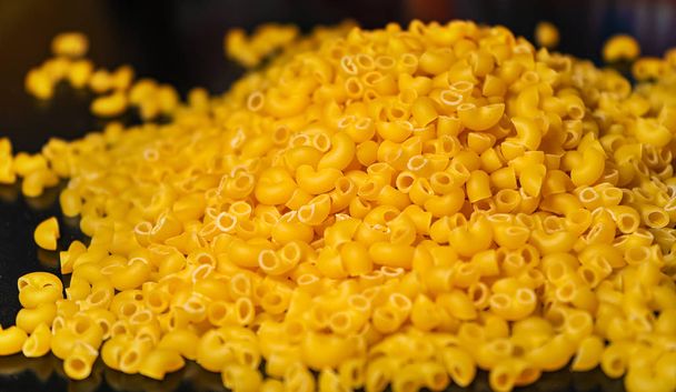 Pasta horns on a black background close-up macro - Φωτογραφία, εικόνα