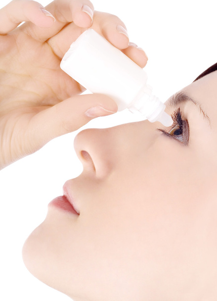 Woman dripping eye with eyes drops - Photo, image