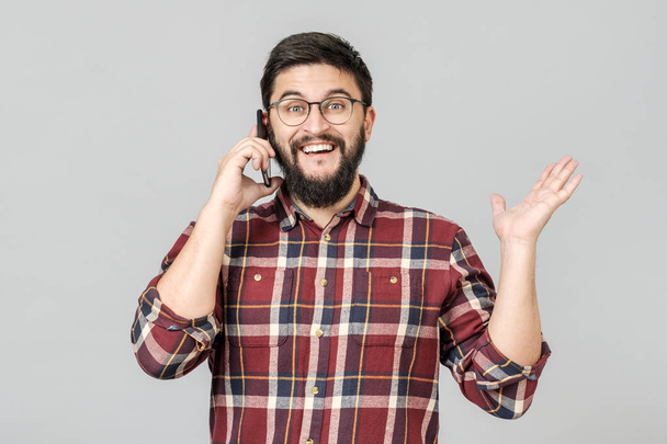 Cheerful happy young man laughing smiling talking on phone - Photo, image