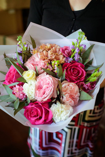 roses, peonies, tulips, bouquet of flowers on a leg in the interior of the restaurant at the celebration shop floristry wedding salon - Foto, imagen