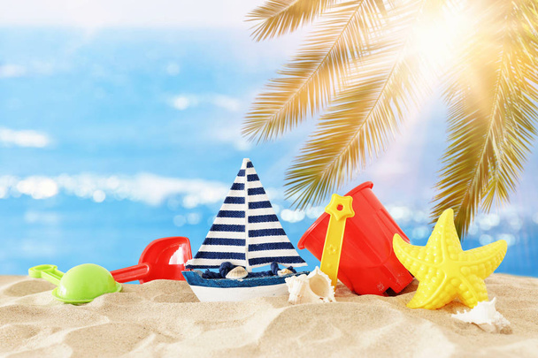 holidays. vacation and summer image with beach colorful toys for kid over the sand - Foto, afbeelding