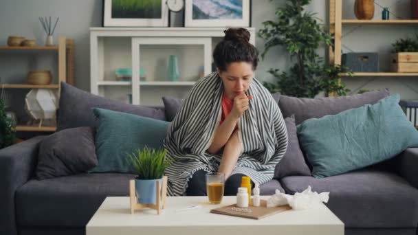 Young woman suffering from disease coughing then drinking medicine at home - Materiał filmowy, wideo