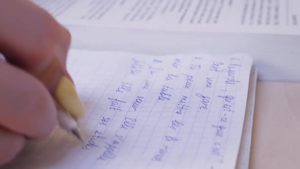 Female Hand Making Notes in Notebook While Studying French - Filmmaterial, Video