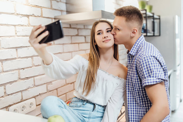 Lovely couple making selfie while cooking at home - Fotoğraf, Görsel
