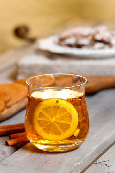 Glass of hot tea on rustic wooden table. Cozy home. - Fotó, kép