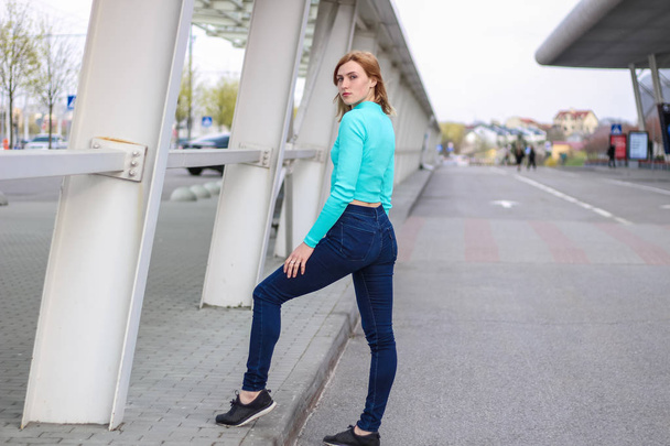 The girl is blonde in a blue croptop. Street clothing. Sport. Ad - Fotoğraf, Görsel