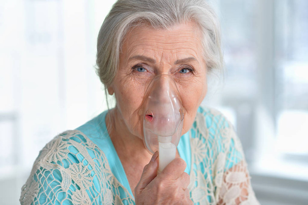 Portrait of elderly woman with flu inhalation - Fotó, kép